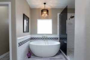Luxurious bathroom with a standalone bathtub, a walk-in shower, and a picture window